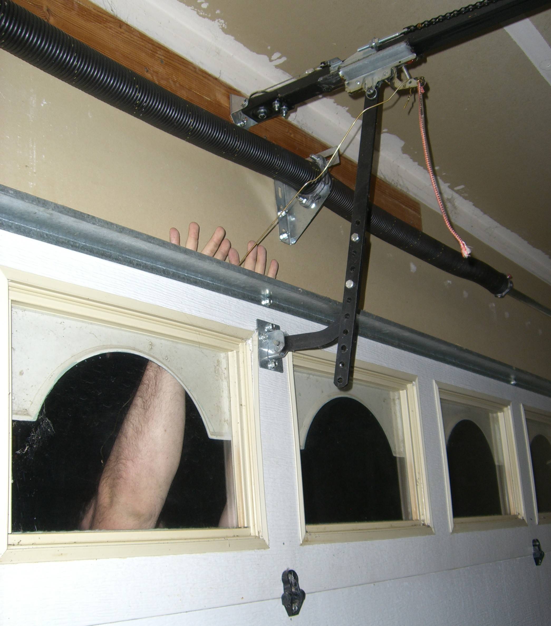 Hanger unlocking electrically-operated garage door